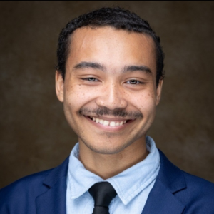 Headshot of Nicholas Robinson-Carter in a blue suit.