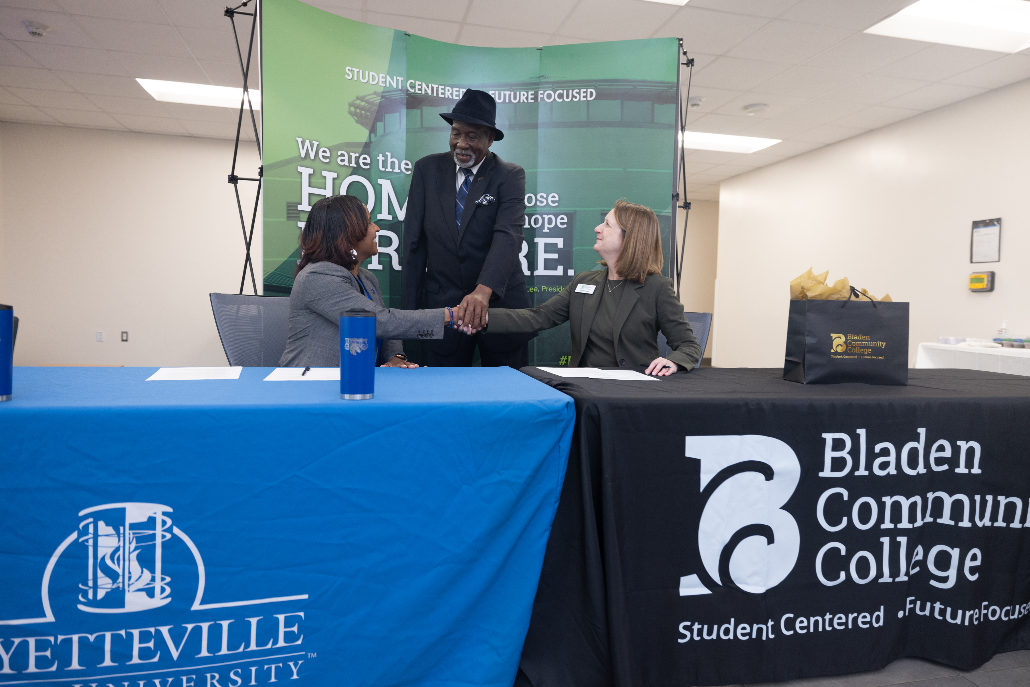 BCC President Amanda Lee, FSU Associate Vice Chancellor, and BCC Board of Trustee shake hands