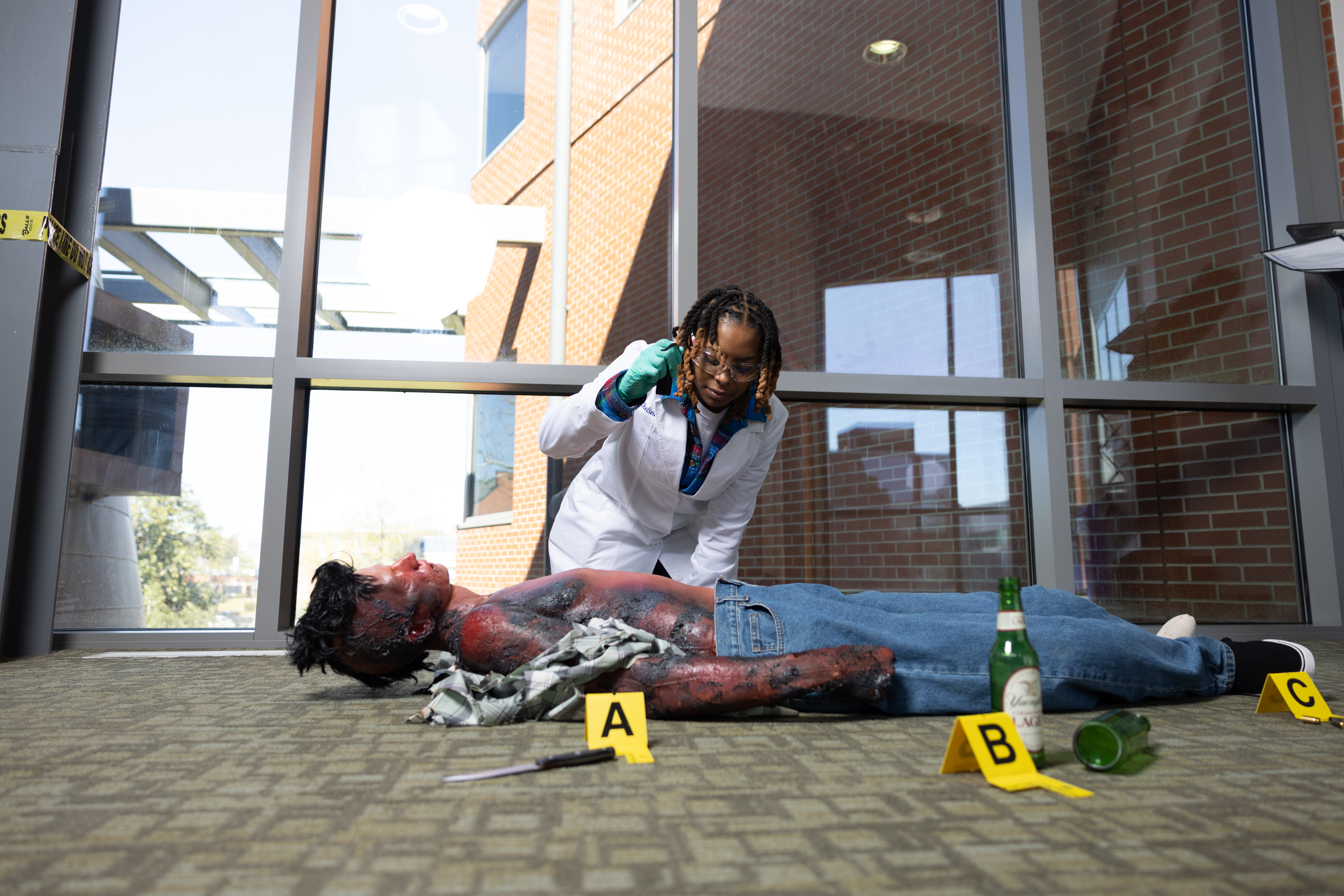 FSU Student examining crime scene of charred mannequin