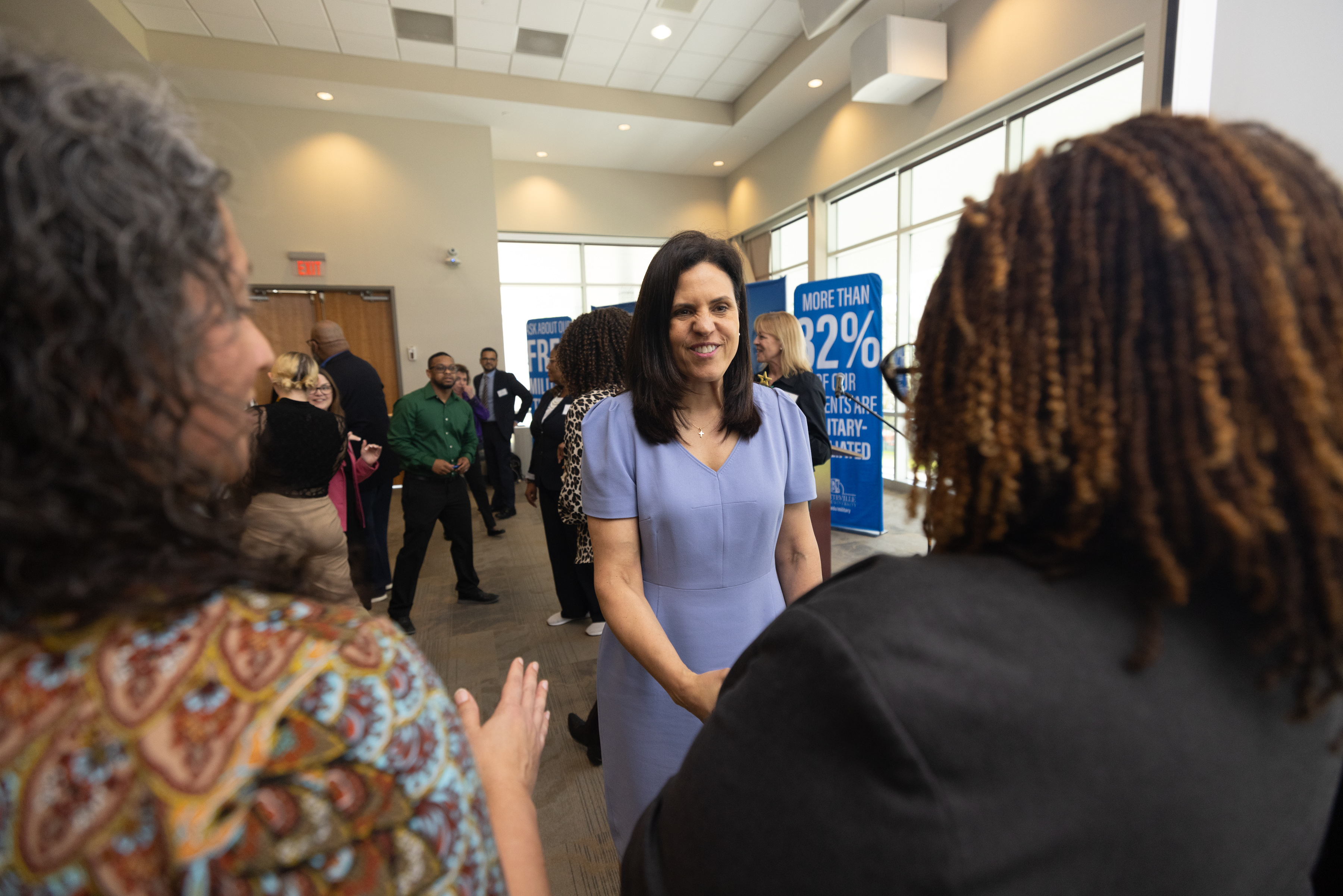 Department of Veterans Affairs Deputy Secretary, Tanya Bradsher, shaking hands with conference participants.