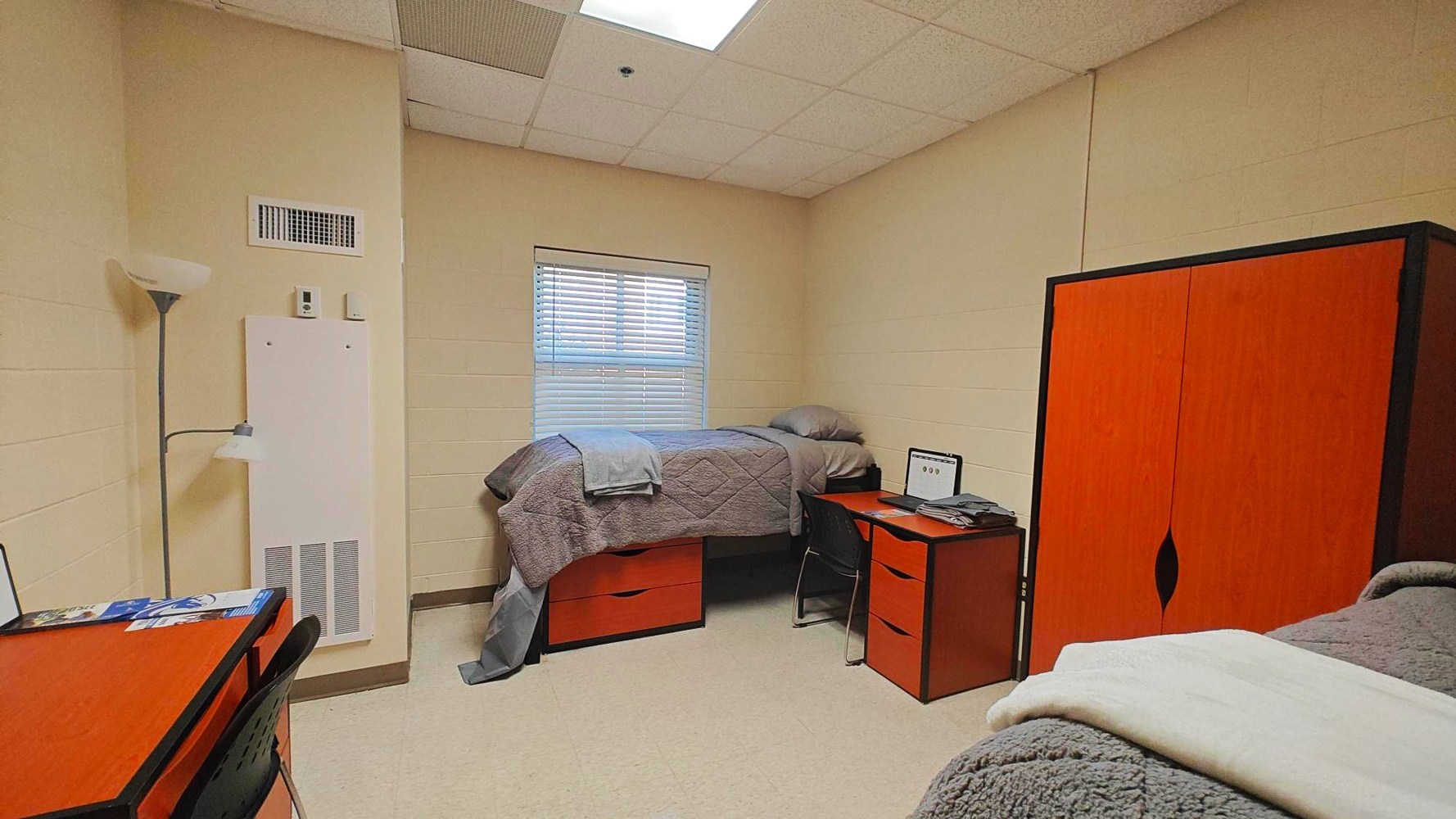 A bedroom with two twin beds, and a red closset.