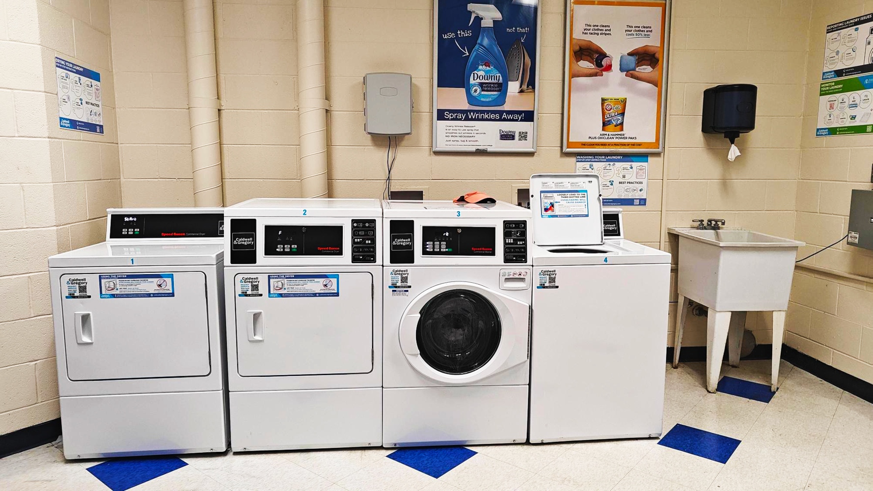 A laundry room with a number of washing machines..