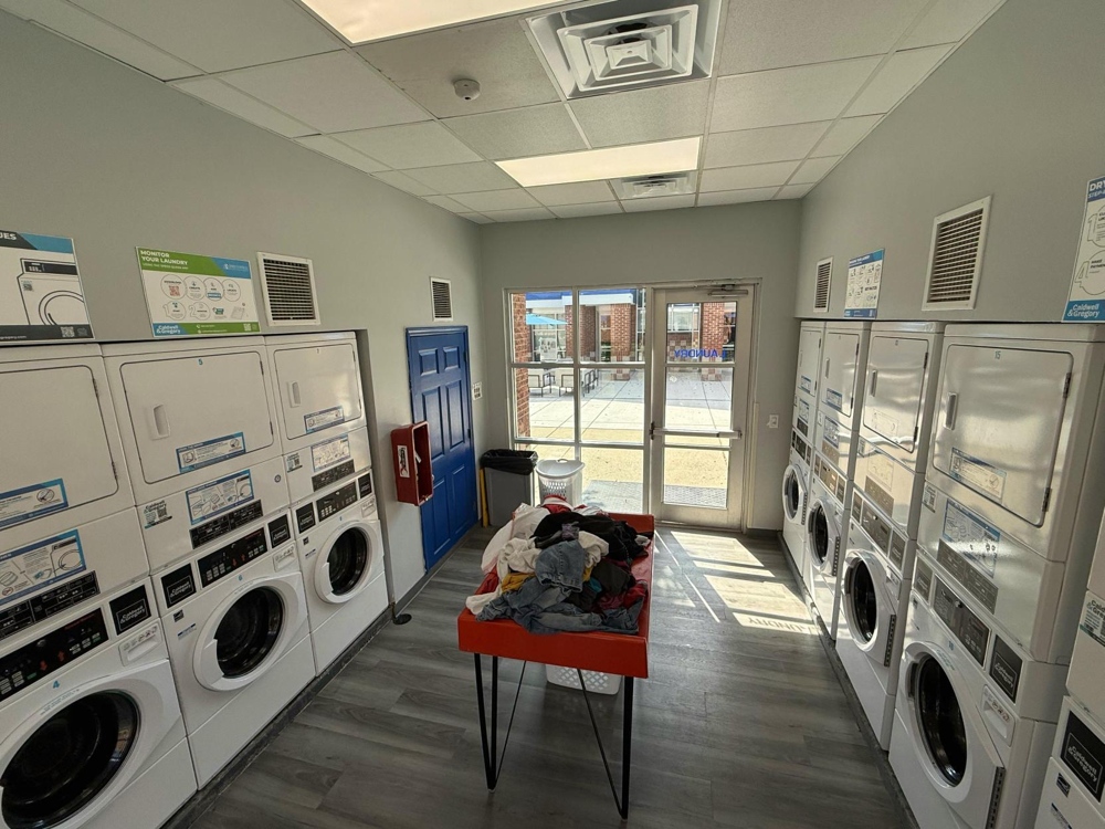 A common laundry room, with numerous washers and dryers available.
