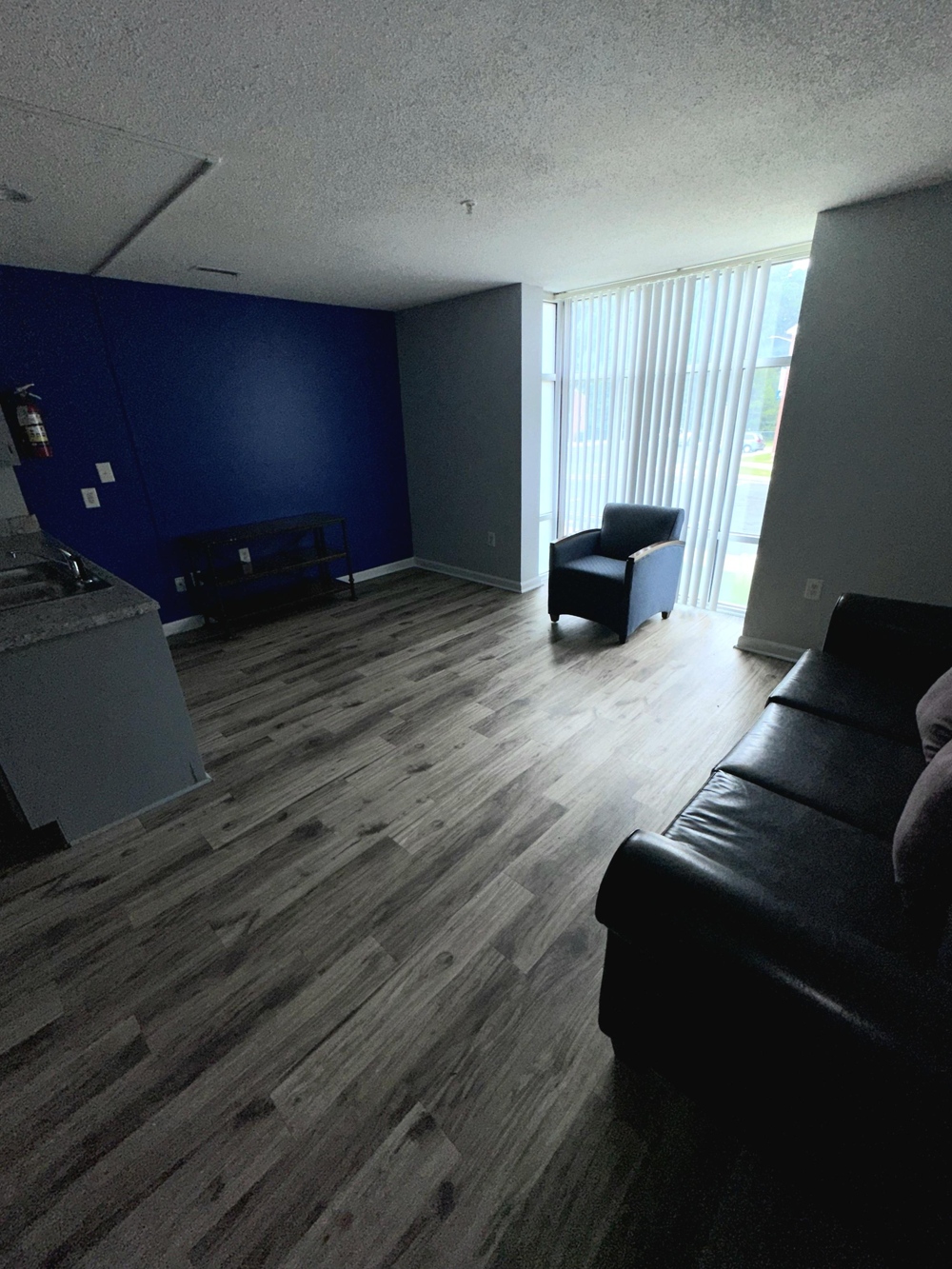 A furnished living area, with couch, chair and coffee table.