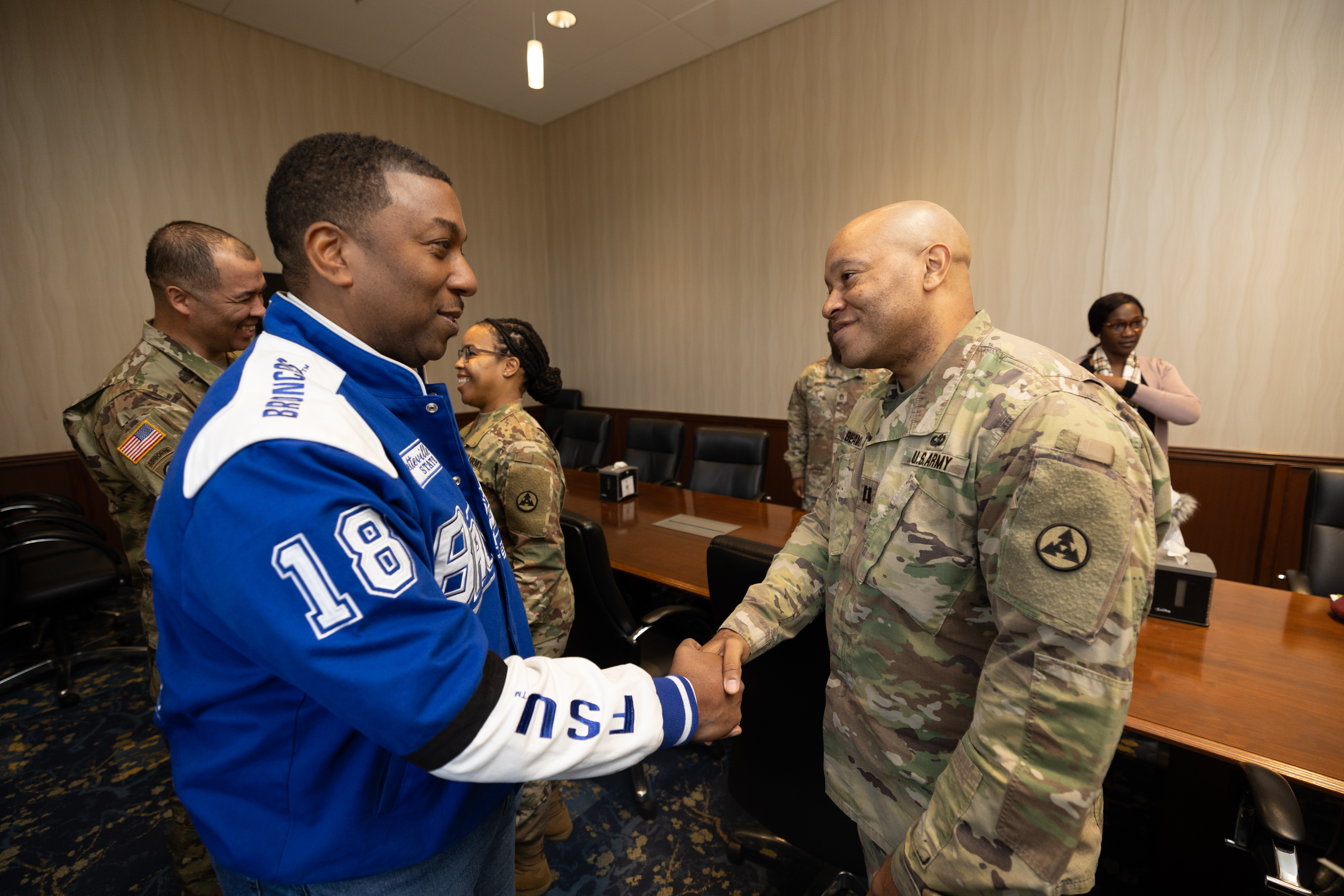 Chancellor Allison shaking hands with Active-Duty Alumni