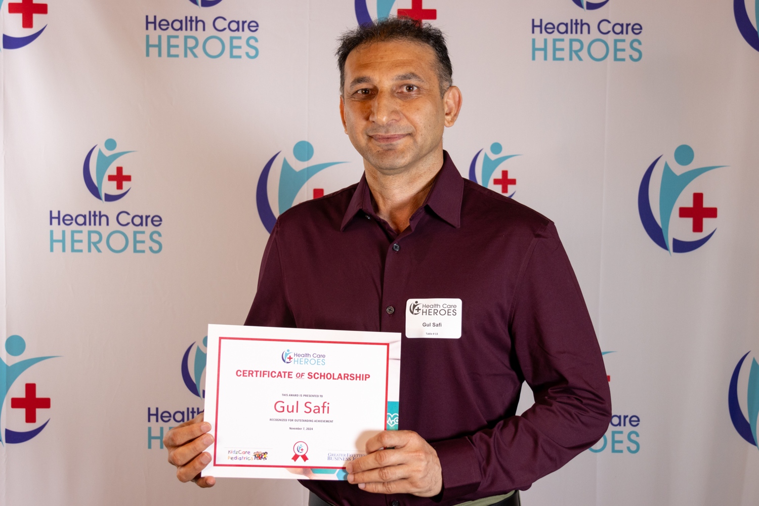 Gul Safi holding an award.