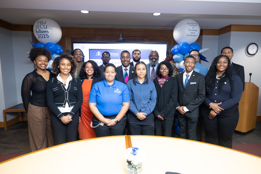 Chancellor Darrell T. Allison standing with students.
