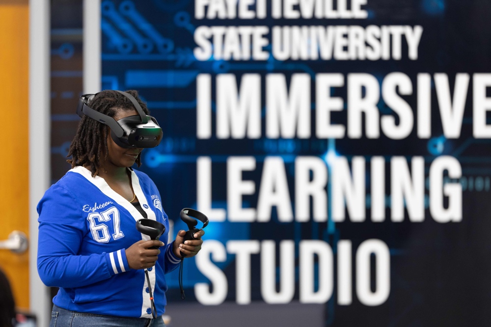 A student in the immersive studio using VR