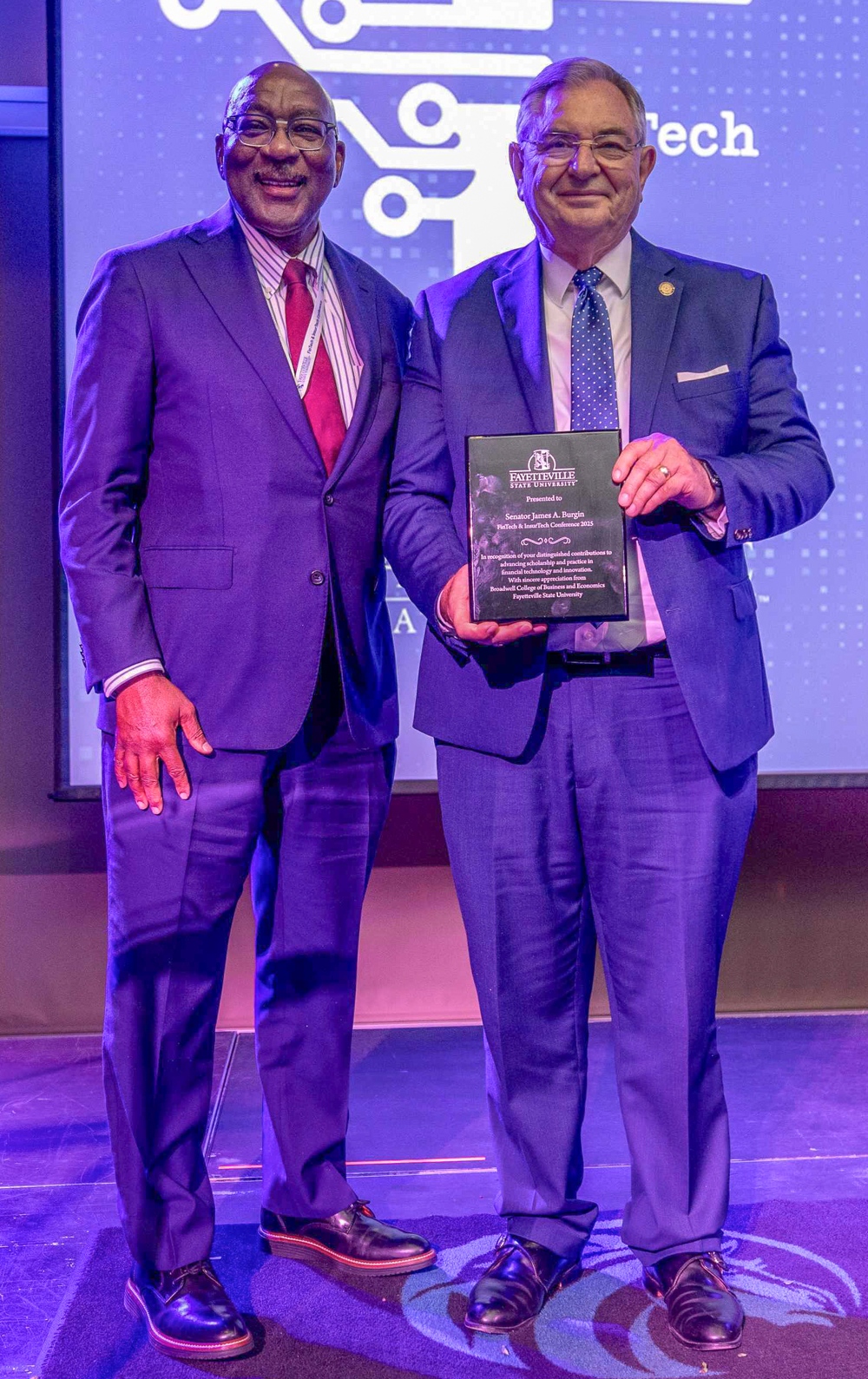 Ulysses Taylor presenting Sen. James “Jim” A. Bergen with an award. 