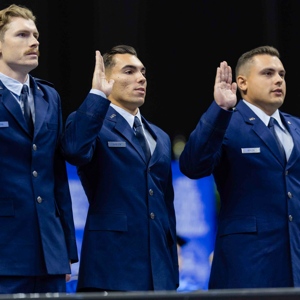 Air Force cadets, holding their right hands up.
