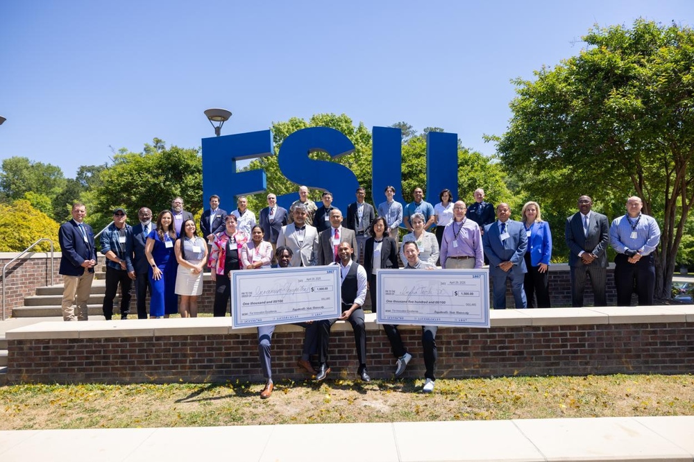 Event winners outside, standing in front of the FSU logo.