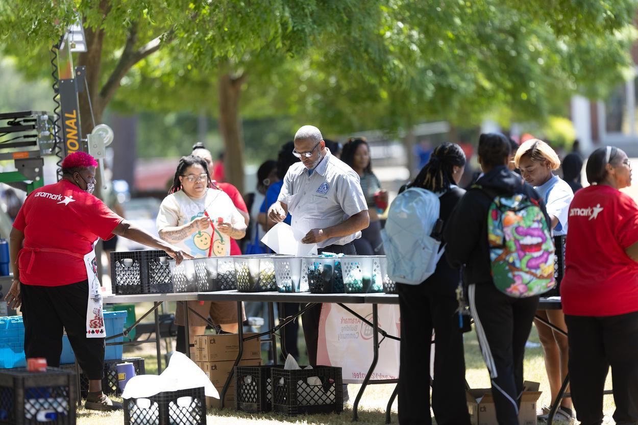 A crowd gathered around a table.