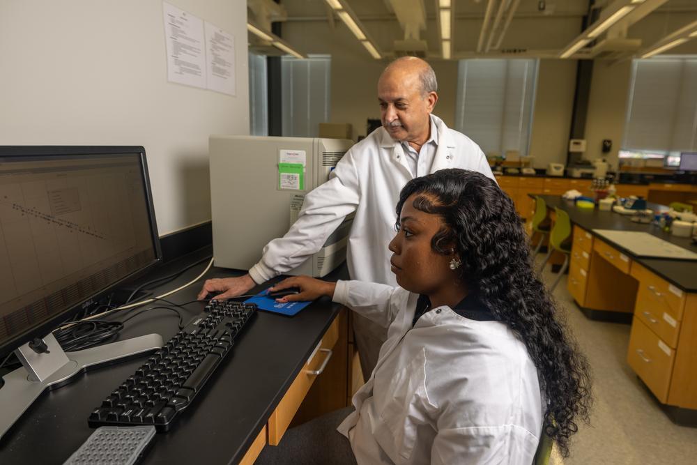 Dr. Lodhi working with a student.