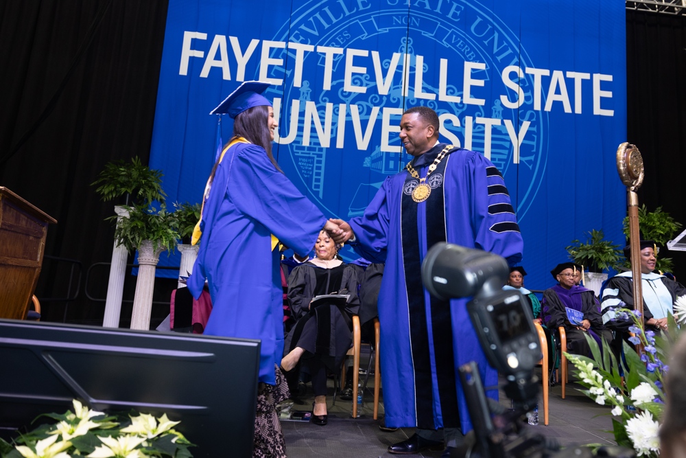 Miriam Delgado shaking the Chancelor's hand at graduation.