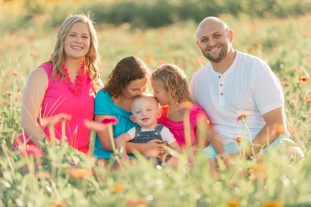 A Yandle family photo, the whole family can be seen sitting smiling in a field.