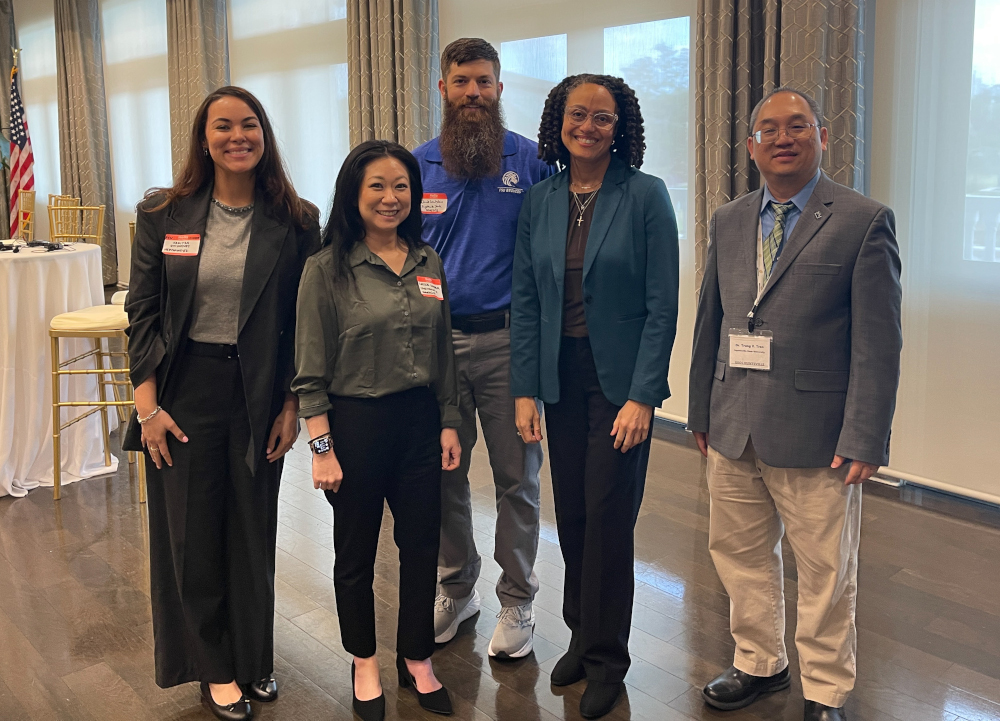 Dr. Dixon standing with colleagues all around them.