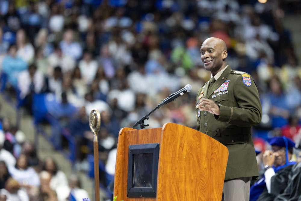 Gen. Xavier T. Brunson standing behind a podium in front of a crowd.