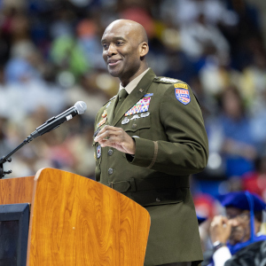 Gen. Xavier T. Brunson standing behind a podium in front of a crowd.