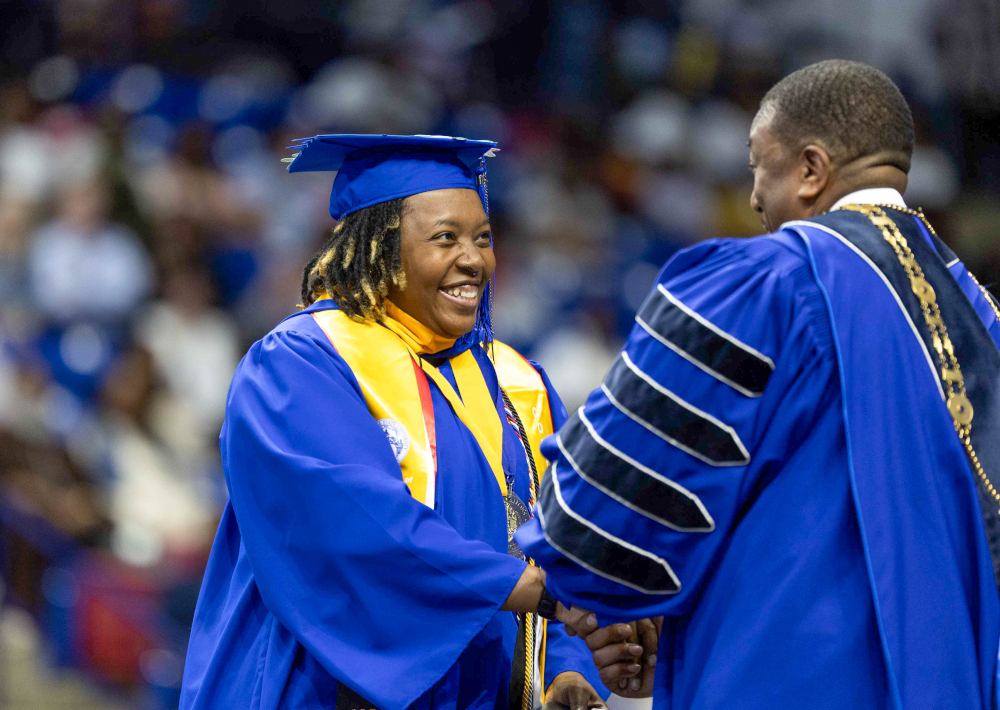 Shereiff Garrett in a cap and gown, smiling.
