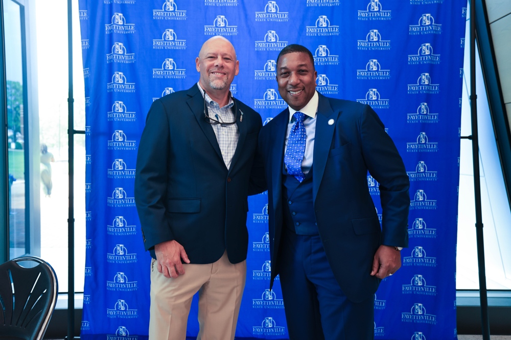 The chancelor standing with the Metcon CEO