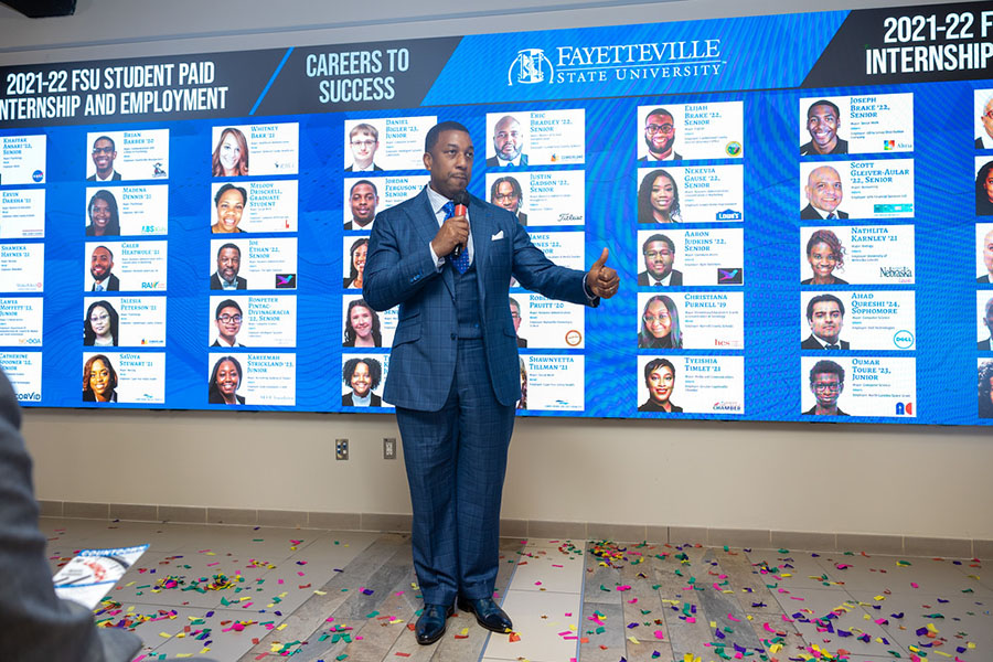 Chancellor in front of Career Wall