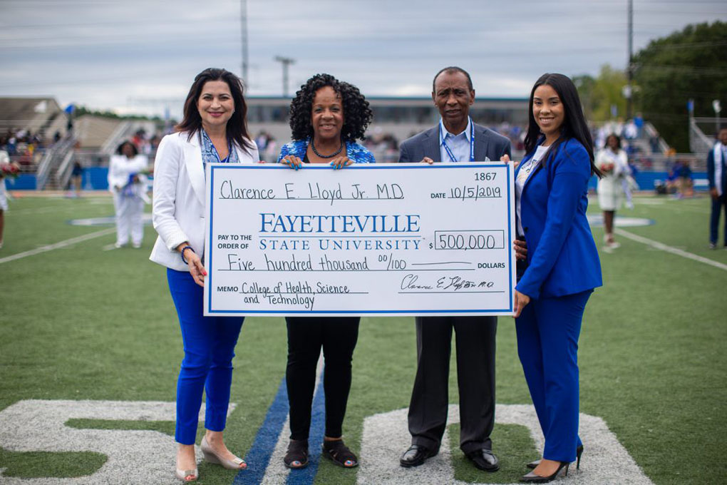 Dr. Clarence Lloyd, second from right, presents Fayetteville State University Interim Chancellor Peggy Valentine, second from left, a check for $500,000. Also pictured from left are Lorna Ricotta, Vice Chancellor for University Advancement, and Jalisha Pone, Associate Director of Development.