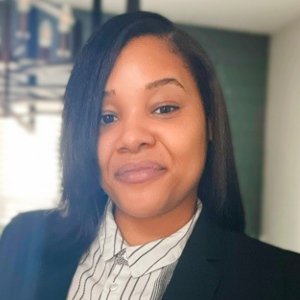 A woman in a black business suit.