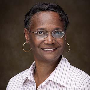 A headshot of Wrenn Crowe in a striped blouse.
