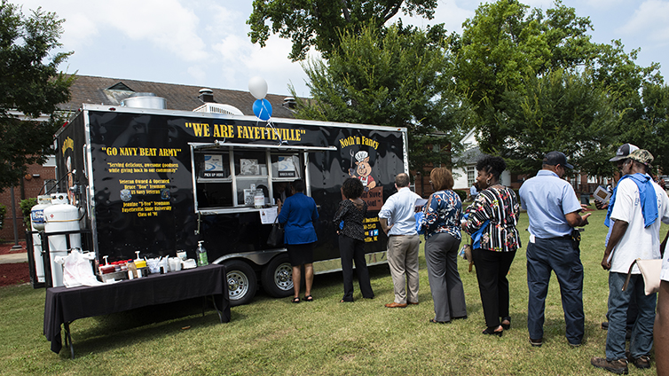 Faculty and staff standing in line at food truck